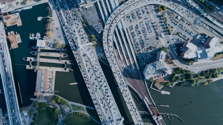 Aerial view of a highway crossing a waterway into an urban area