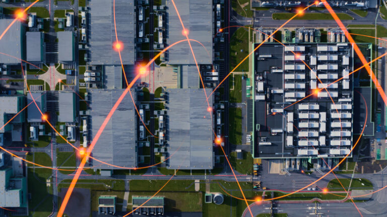 Aerial shot of manufacturing facility with lines of light indicating connections from all different parts of the site.